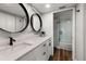 Modern bathroom featuring dual mirrors, white cabinets, and a glass shower door at 1324 Pasadena S Ave # 204, South Pasadena, FL 33707