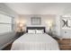 Relaxing bedroom with bright white comforter and dual side tables at 1324 Pasadena S Ave # 204, South Pasadena, FL 33707