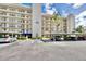 Exterior view of a condo building with parking and landscaping on a sunny day at 1324 Pasadena S Ave # 204, South Pasadena, FL 33707