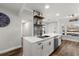 Bright kitchen featuring white cabinetry, stainless steel appliances, and modern backsplash design at 1324 Pasadena S Ave # 204, South Pasadena, FL 33707