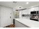 Updated kitchen with white cabinets, quartz countertops, and stainless steel appliances at 1324 Pasadena S Ave # 204, South Pasadena, FL 33707