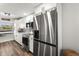 Contemporary kitchen with stainless steel refrigerator, oven, microwave, and white cabinetry at 1324 Pasadena S Ave # 204, South Pasadena, FL 33707