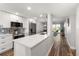 Modern kitchen with stainless steel appliances and open floor plan to living area at 1324 Pasadena S Ave # 204, South Pasadena, FL 33707