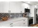 Modern kitchen showcases white cabinets, stainless steel appliances, and decorative backsplash at 1324 Pasadena S Ave # 204, South Pasadena, FL 33707
