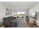 Comfortable living room with modern furniture, flat screen TV, and access to balcony at 1324 Pasadena S Ave # 204, South Pasadena, FL 33707
