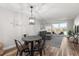 Cozy living space with gray sectional couch, dining area, and access to balcony at 1324 Pasadena S Ave # 204, South Pasadena, FL 33707