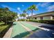 Outdoor shuffleboard courts, with tropical landscaping and a building in the background at 1324 Pasadena S Ave # 204, South Pasadena, FL 33707