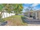 Spacious backyard featuring well-maintained lawn and partially covered patio at 13826 Pathfinder Dr, Tampa, FL 33625