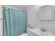 Clean bathroom with a blue shower curtain, white sink, and toilet at 13826 Pathfinder Dr, Tampa, FL 33625
