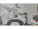 Cozy bedroom with light wood-look flooring, neutral walls, and a comfortable bed with stylish decor at 13826 Pathfinder Dr, Tampa, FL 33625