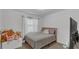 Cozy bedroom with soft pink accents, a plush bed, and natural light at 13826 Pathfinder Dr, Tampa, FL 33625