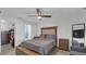 Bedroom with wood flooring has modern ceiling fan and updated ensuite bathroom at 13826 Pathfinder Dr, Tampa, FL 33625