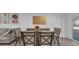 Dining area with a rustic wood table, fabric chairs and bench seating adjacent to the living area at 13826 Pathfinder Dr, Tampa, FL 33625