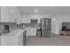 Contemporary kitchen with white cabinetry, stainless steel appliances, and light countertops at 13826 Pathfinder Dr, Tampa, FL 33625