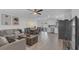 Open-concept living space with wood-look flooring, dining area and stainless steel appliances in kitchen at 13826 Pathfinder Dr, Tampa, FL 33625