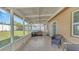 Outdoor screened patio with tiled floor and backyard views at 13826 Pathfinder Dr, Tampa, FL 33625