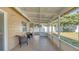 Enclosed back patio with tile floor, brick wall and neutral decor at 13826 Pathfinder Dr, Tampa, FL 33625