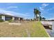 Exterior of the home featuring a waterfront backyard, a patio, and scenic water views at 1518 New Bedford Dr, Sun City Center, FL 33573