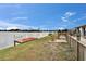 Scenic backyard showcasing lush greenery, waterside dock and tranquil water views at 1518 New Bedford Dr, Sun City Center, FL 33573