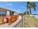 Home features a covered patio with ample seating, overlooking the lush green yard and waterfront views at 1518 New Bedford Dr, Sun City Center, FL 33573