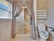 Bathroom featuring a shower with curtain and safety bars, along with a comfort-height toilet at 1518 New Bedford Dr, Sun City Center, FL 33573