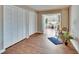 Bedroom featuring laminated floors, closet with louvered doors, and large windows that leads to the patio at 1518 New Bedford Dr, Sun City Center, FL 33573