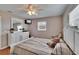 Bedroom featuring a bed, TV, and a dresser with decorative lamps at 1518 New Bedford Dr, Sun City Center, FL 33573