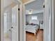 Bedroom featuring wood floors with a view into the bathroom at 1518 New Bedford Dr, Sun City Center, FL 33573