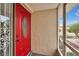 The inviting front entrance features a striking red door with decorative glass, and a secure screen enclosure at 1518 New Bedford Dr, Sun City Center, FL 33573