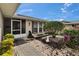 Inviting front entrance featuring a screened door, decorative landscaping, and charming walkway pavers at 1518 New Bedford Dr, Sun City Center, FL 33573