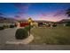 Charming single story home with a red garage door at dusk at 1518 New Bedford Dr, Sun City Center, FL 33573