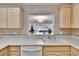 Bright kitchen featuring updated countertops and cabinetry with a convenient pass-through to the living area at 1518 New Bedford Dr, Sun City Center, FL 33573