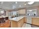 Open kitchen with light wood cabinetry and dining area at 1518 New Bedford Dr, Sun City Center, FL 33573