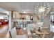 Bright kitchen featuring wooden cabinets, quartz countertops, bar seating, and a modern glass dining table at 1518 New Bedford Dr, Sun City Center, FL 33573