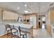 Bright kitchen with a breakfast bar, white appliances, and tiled floors for a clean, modern look at 1518 New Bedford Dr, Sun City Center, FL 33573