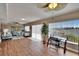Spacious living room with laminated floors, a ceiling fan, large windows and comfortable seating at 1518 New Bedford Dr, Sun City Center, FL 33573