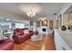 Comfortable living room boasts a fireplace, hardwood floors, and stylish furnishings at 1518 New Bedford Dr, Sun City Center, FL 33573