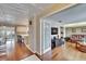 Open concept, light-filled room with hardwood floors seamlessly transitioning to a connecting kitchen area at 1518 New Bedford Dr, Sun City Center, FL 33573