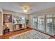Bright living room with wooden floors, vintage cabinet and access to backyard patio at 1518 New Bedford Dr, Sun City Center, FL 33573