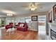Open living space with hardwood floors, fireplace, French doors and comfortable seating at 1518 New Bedford Dr, Sun City Center, FL 33573