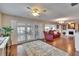 Cozy living room with hardwood floors, a ceiling fan, and French doors leading to outdoor space at 1518 New Bedford Dr, Sun City Center, FL 33573