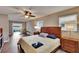Main bedroom with wood floors, ensuite balcony, and generous natural light at 1518 New Bedford Dr, Sun City Center, FL 33573