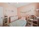 Stylish bedroom featuring a bed frame, a dollhouse, and decorative wall hangings at 16222 Silent Sands Ln, Odessa, FL 33556