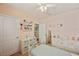 Cute bedroom with a white bed frame, matching dresser, and decorative shelving at 16222 Silent Sands Ln, Odessa, FL 33556