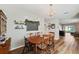 Cozy dining room featuring wood table, decorative chalkboard, and stylish chandelier at 16222 Silent Sands Ln, Odessa, FL 33556