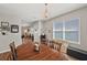Inviting dining room with window view, hardwood table and floors, with natural lighting at 16222 Silent Sands Ln, Odessa, FL 33556