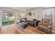 Comfortable living room with hardwood floors and sliding glass doors to backyard at 16222 Silent Sands Ln, Odessa, FL 33556