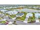 Aerial view of property in a community near a lake, showcasing well-manicured landscaping at 17541 Corkwood Bend Trl, Punta Gorda, FL 33982