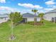 An aerial view of the spacious backyard, a screened lanai, and a well-maintained lawn at 17541 Corkwood Bend Trl, Punta Gorda, FL 33982