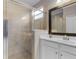 Bathroom featuring a glass enclosed shower and white vanity with dark trimmed mirror at 17541 Corkwood Bend Trl, Punta Gorda, FL 33982